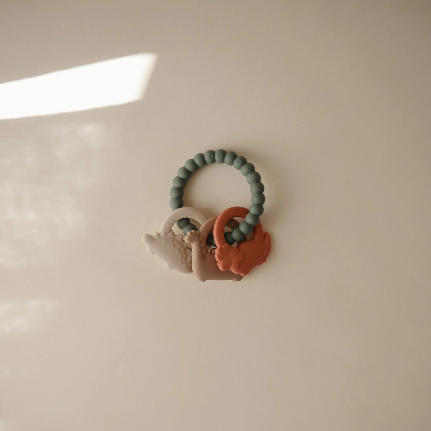 Dino Teething Ring with Sensory Shapes and Textures Mushie Everetts Place: Online Boutique