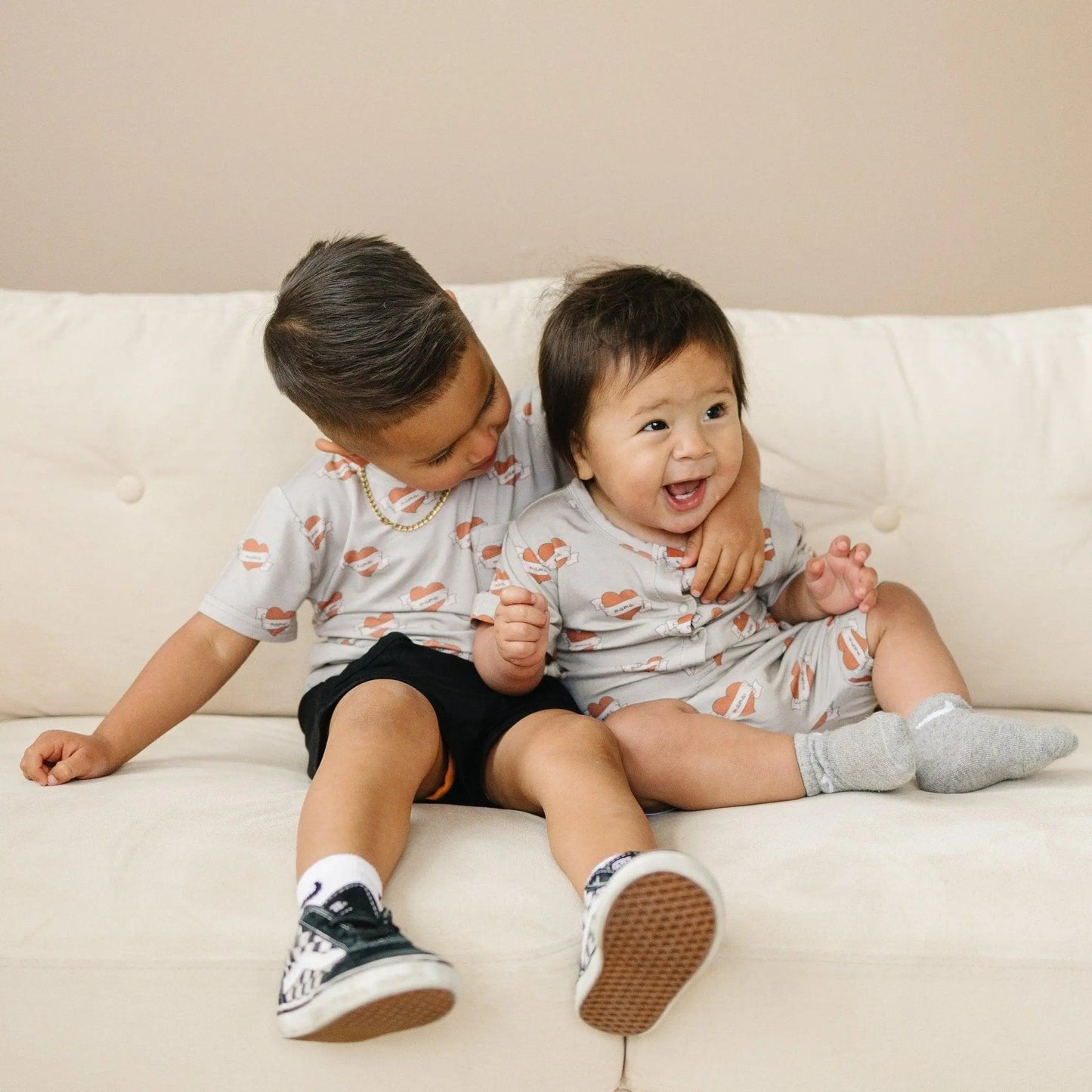 Little Joy Co. Mama Tattoo Hearts Bamboo Henley Romper for Babies - Apparel & Accessories > Clothing > Baby & Toddler Clothing > Baby One-Pieces