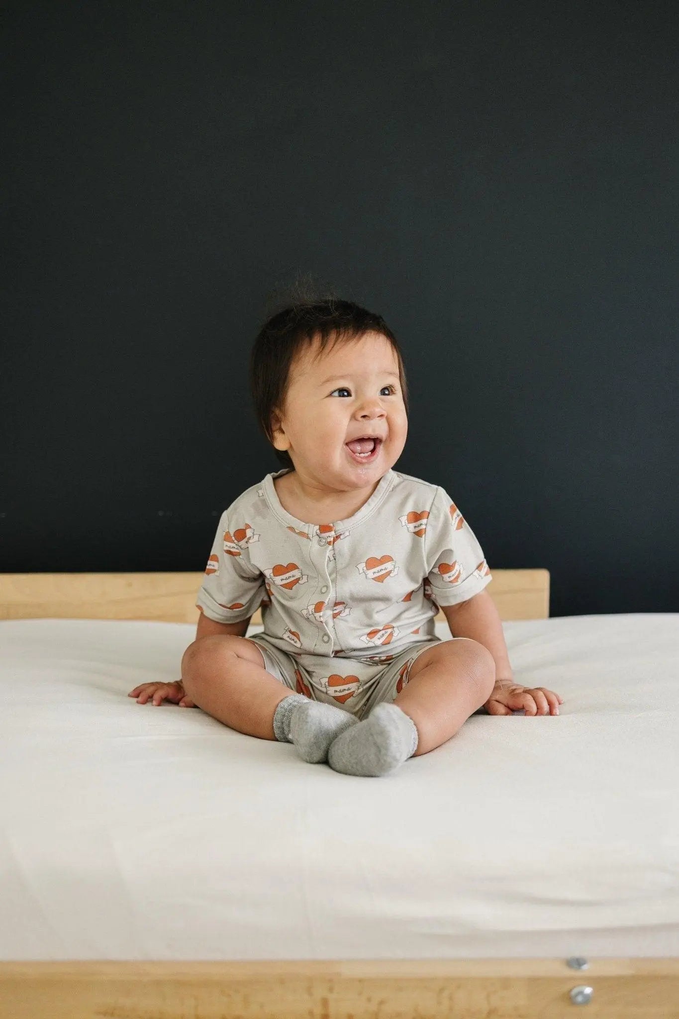 Little Joy Co. Mama Tattoo Hearts Bamboo Henley Romper for Babies - Apparel & Accessories > Clothing > Baby & Toddler Clothing > Baby One-Pieces