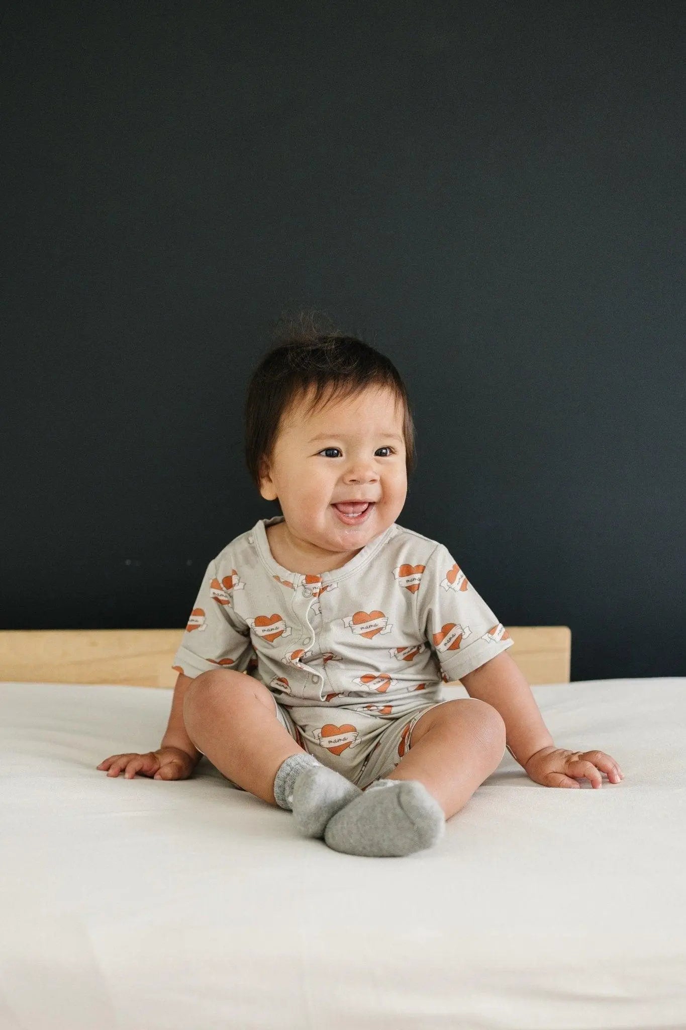 Little Joy Co. Mama Tattoo Hearts Bamboo Henley Romper for Babies - Apparel & Accessories > Clothing > Baby & Toddler Clothing > Baby One-Pieces