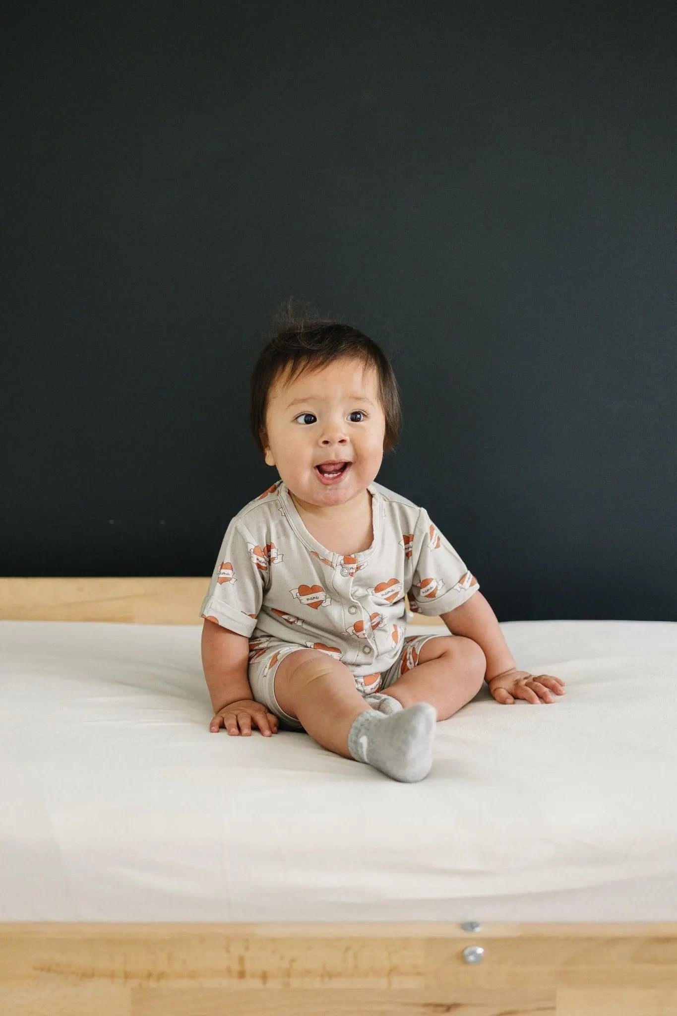 Little Joy Co. Mama Tattoo Hearts Bamboo Henley Romper for Babies - Apparel & Accessories > Clothing > Baby & Toddler Clothing > Baby One-Pieces