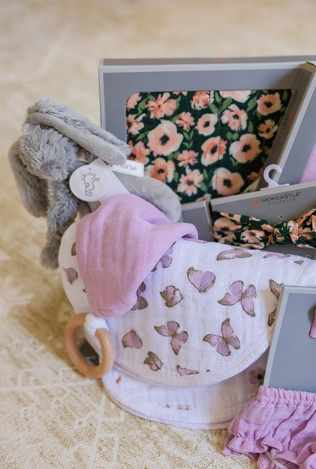 Welcome Baby Girl Flowers and Butterfly Gift Basket with Bamboo Blanket Floral Headband Swaddle Bib Teether and Plush Rabbit Newcastle Classics