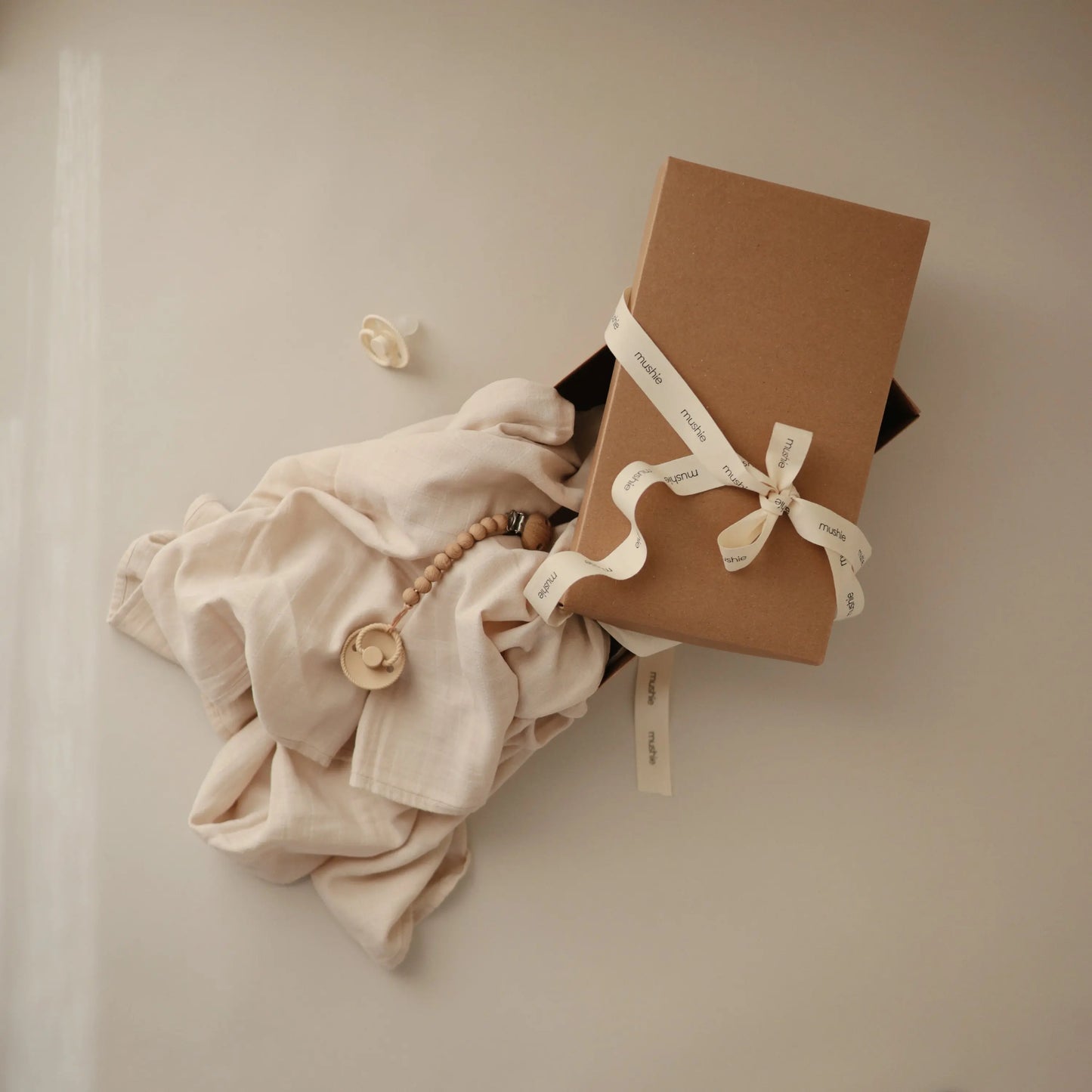 Newborn Mini Gift Set with Organic Cotton Muslin Swaddle FRIGG Daisy Night Pacifiers and Hera Silicone Pacifier Clip Mushie Everetts Place: Online Boutique