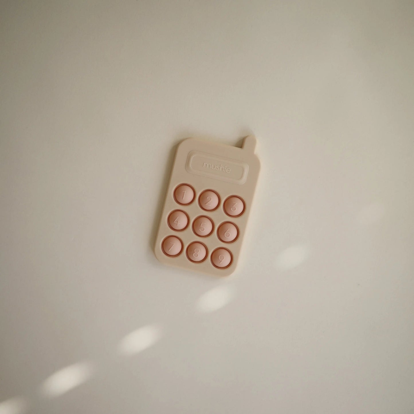 Phone Press Toy for Sensory Exploration and Fine Motor Skill Development Mushie Everetts Place: Online Boutique