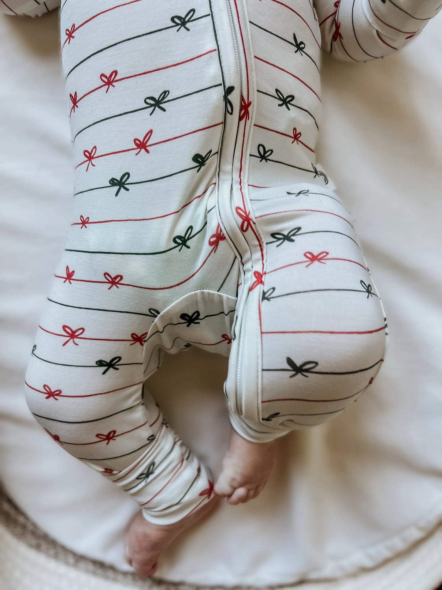 Tied With a Bow Christmas Bamboo Zippy Romper for Babies Little Joy Co. Everetts Place: Online Boutique