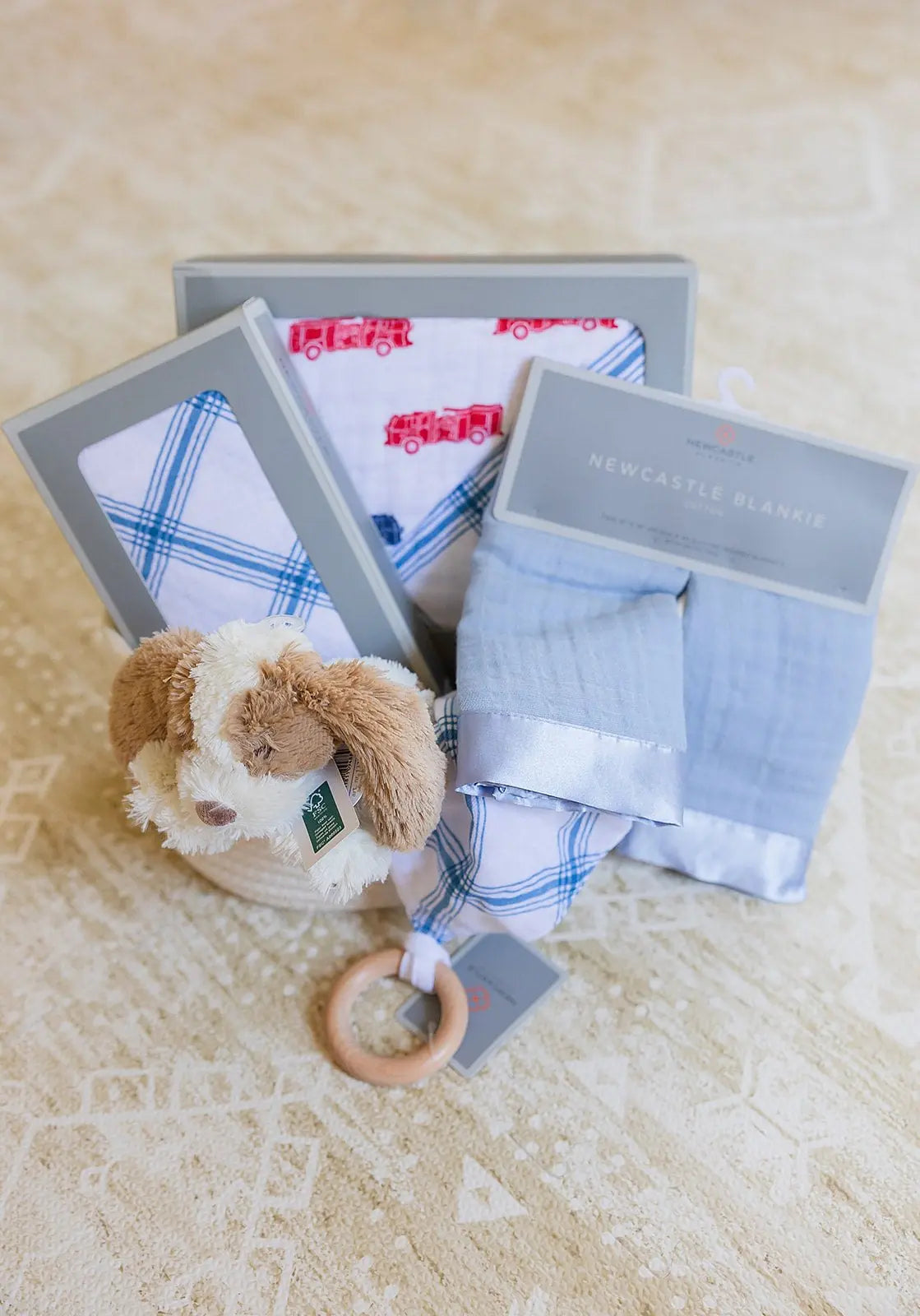 Welcome Baby Boy Firetruck and Blue Plaid Basket with Cotton Blanket Swaddle Blankie Set and Plush Dog Toy Newcastle Classics