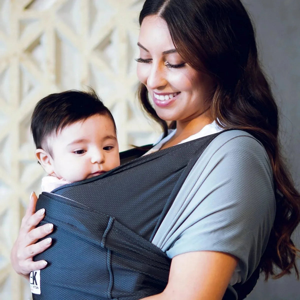 Baby K'tan: The Perfect Baby Carrier for Parents, featuring a parent holding a baby comfortably in a wrap-style carrier.