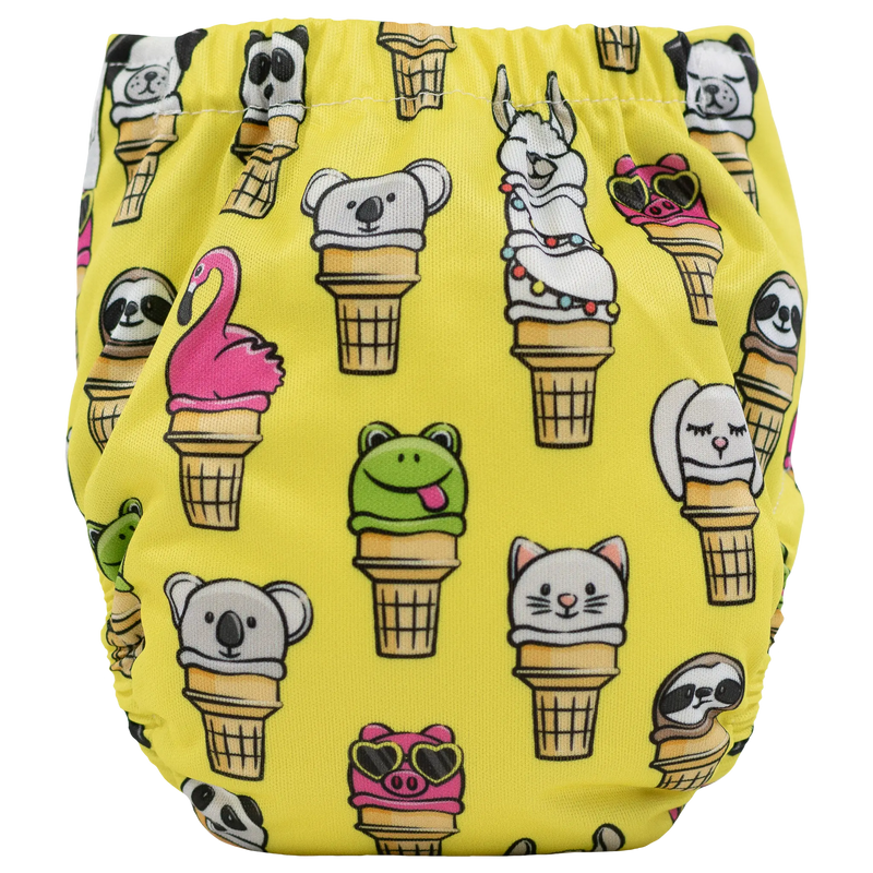 Tiny Tushies Newborn AIO Cloth Diaper with playful animal and ice cream cone print on yellow background.