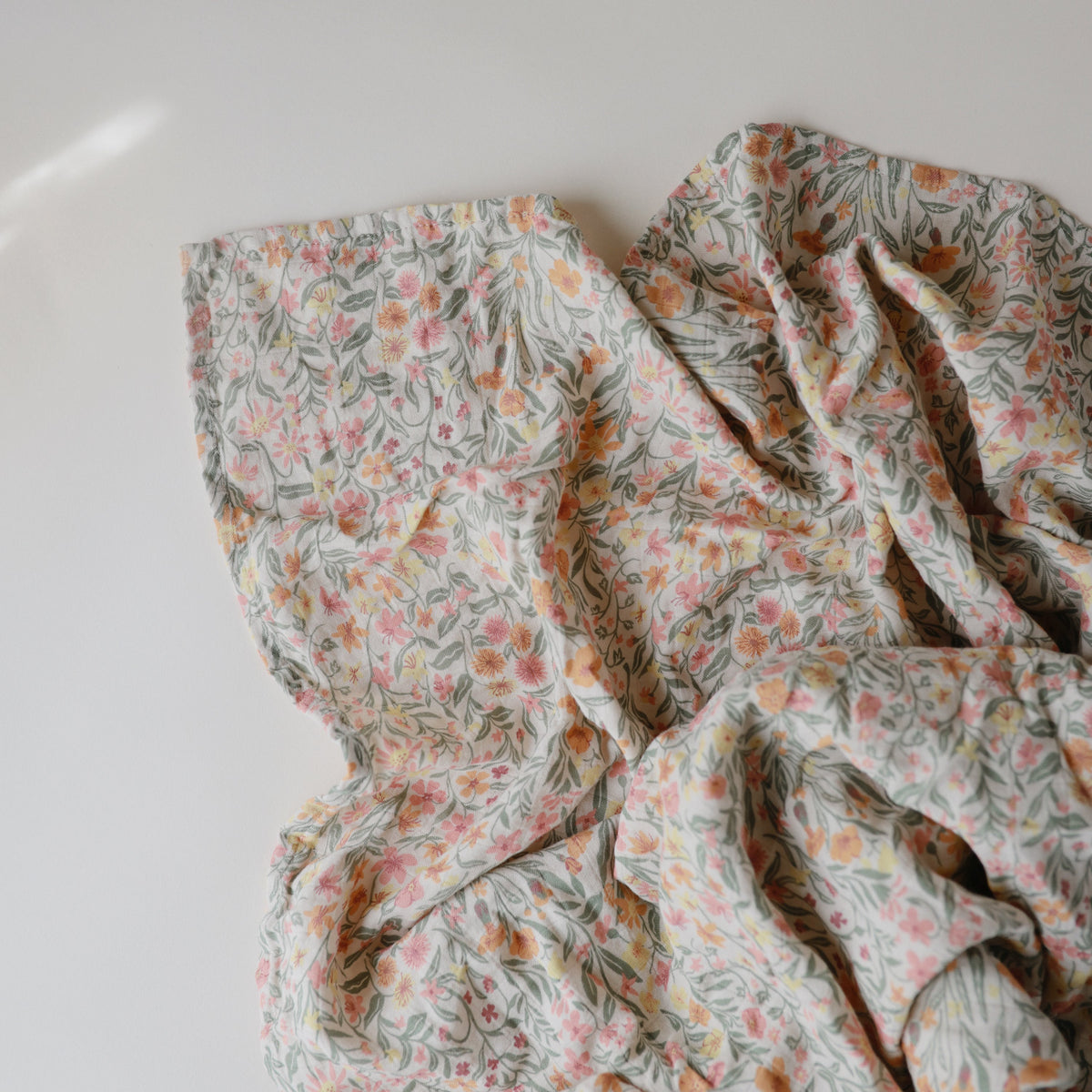 Mushie organic cotton muslin swaddle blanket, soft & breathable.