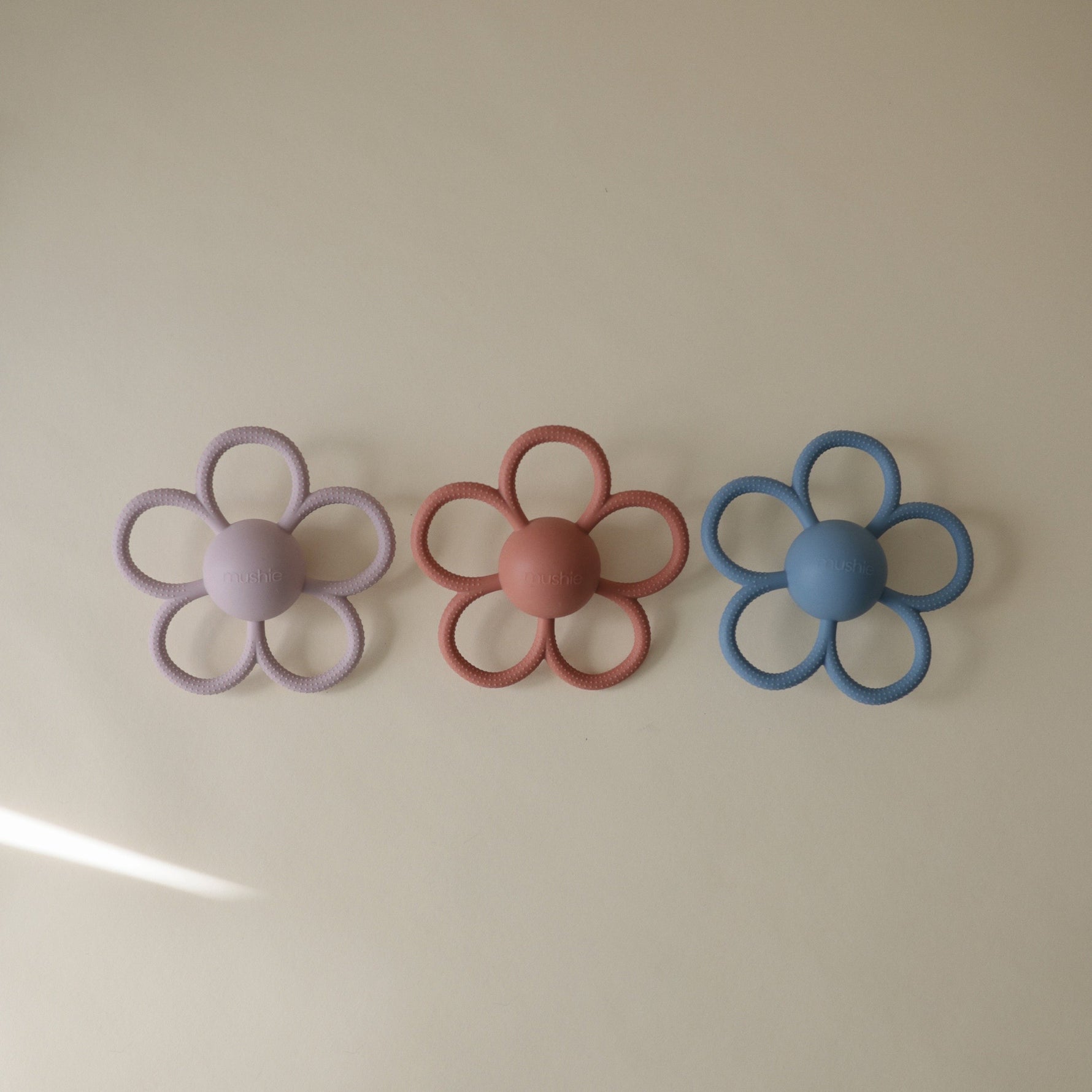 Mushie Daisy Rattle Teether, safe silicone baby toy.