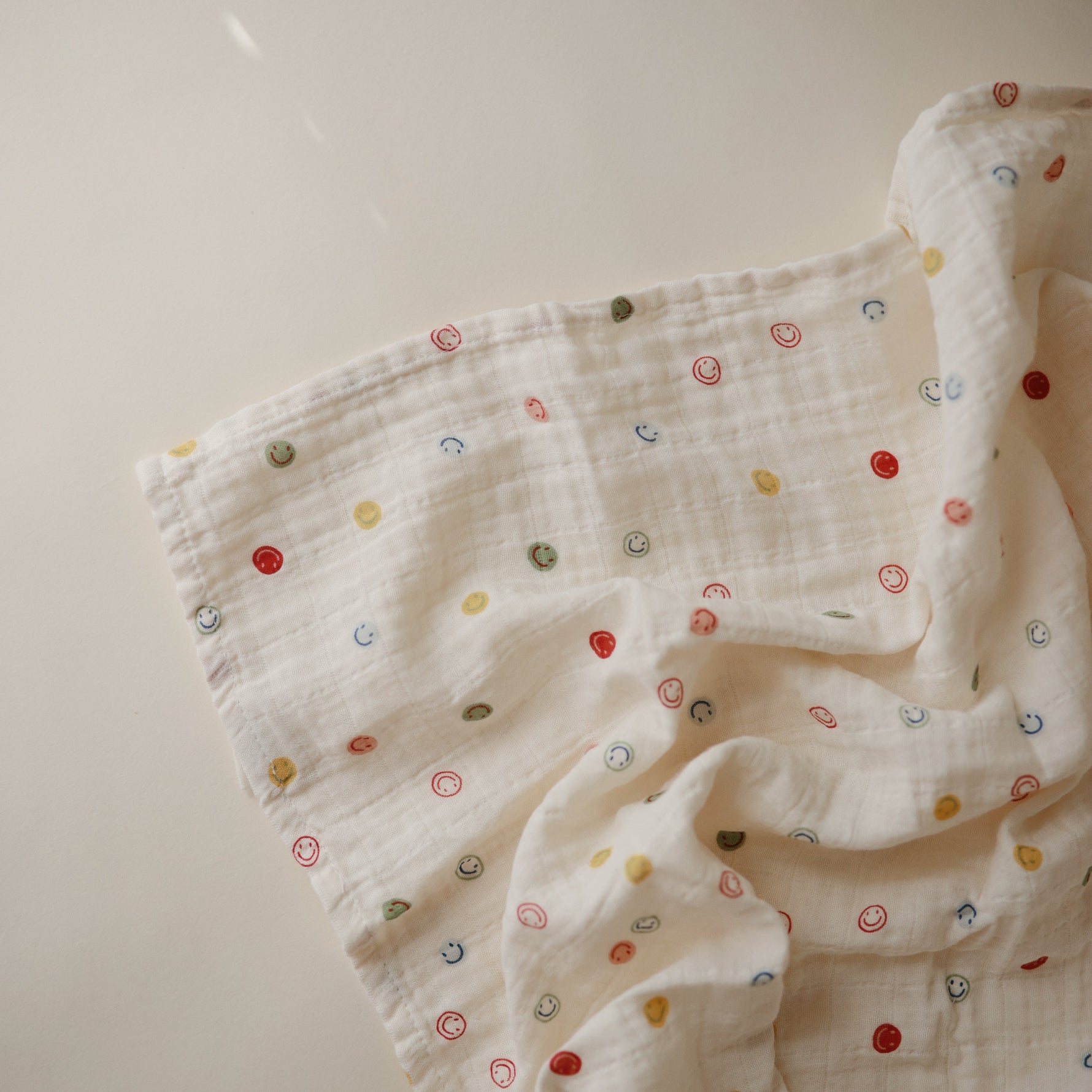 Mushie organic cotton muslin swaddle blanket, soft and breathable.