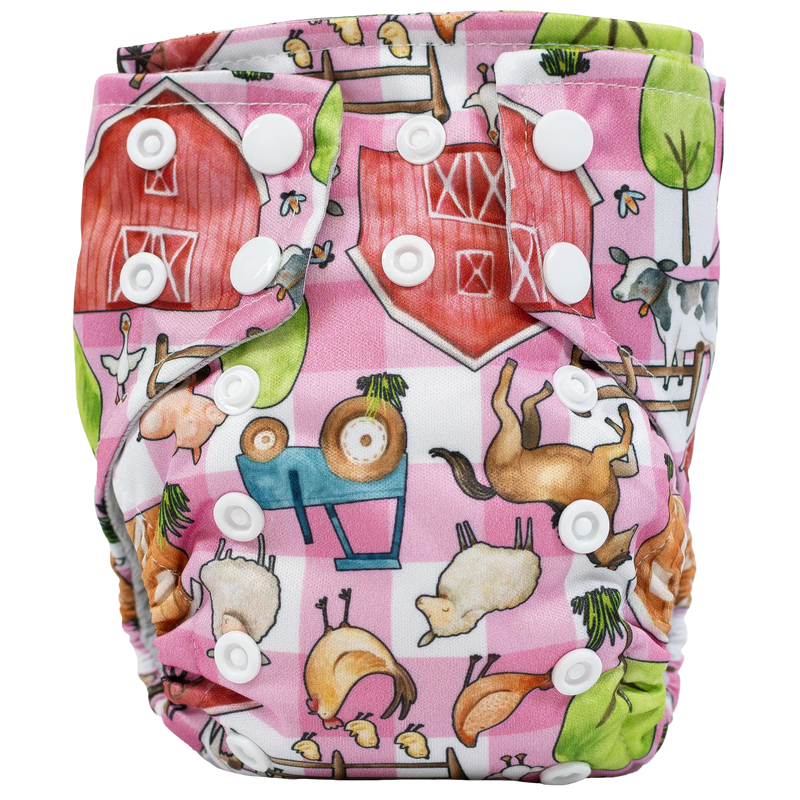 Tiny Tushies Newborn AIO Cloth Diaper with colorful farm animal print and white snaps.