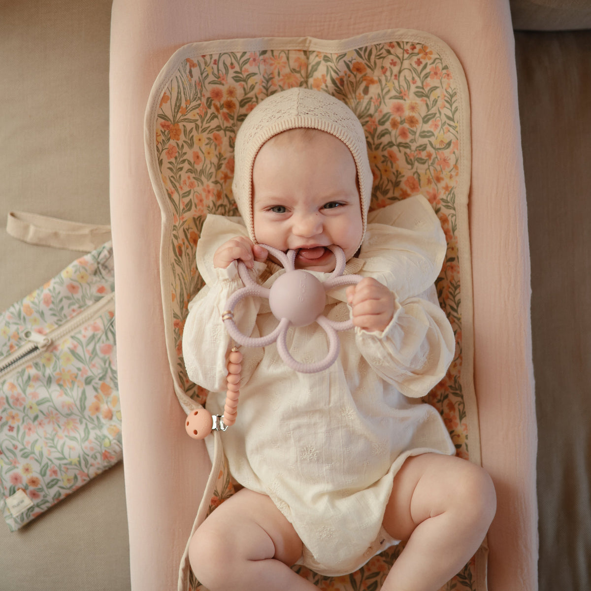 Mushie Daisy Rattle Teether, a flower-shaped baby toy.