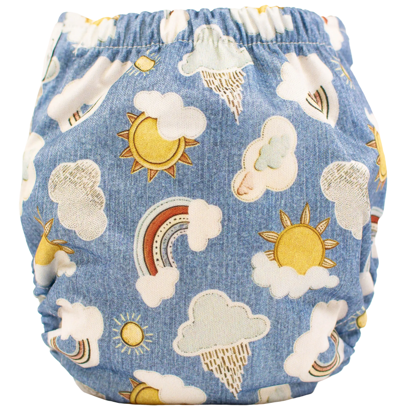 Tiny Tushies Newborn AIO Cloth Diaper with cloud and sun pattern, featuring adjustable rise setting and pocket opening for inserts.