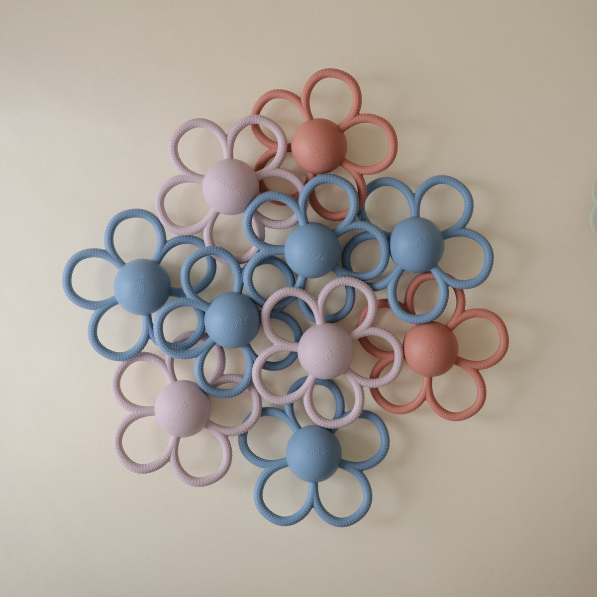 Mushie Daisy Rattle Teether. Soft silicone baby teether rattle.
