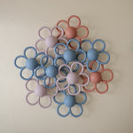 Mushie Daisy Rattle Teether. Soft silicone baby teether rattle.