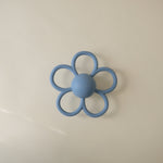 Mushie Daisy Rattle Teether, a white floral baby rattle and teether.