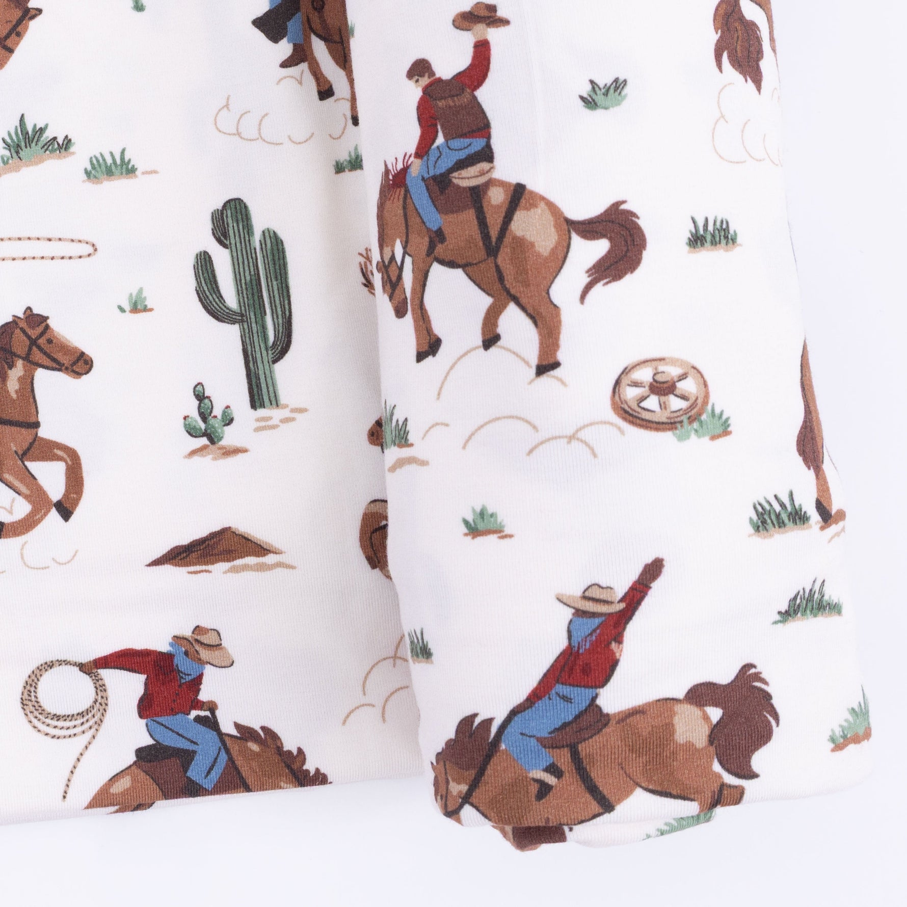 Angel Dear Buckaroo Western swaddle blanket with cowboy hats, boots, and bandanas pattern