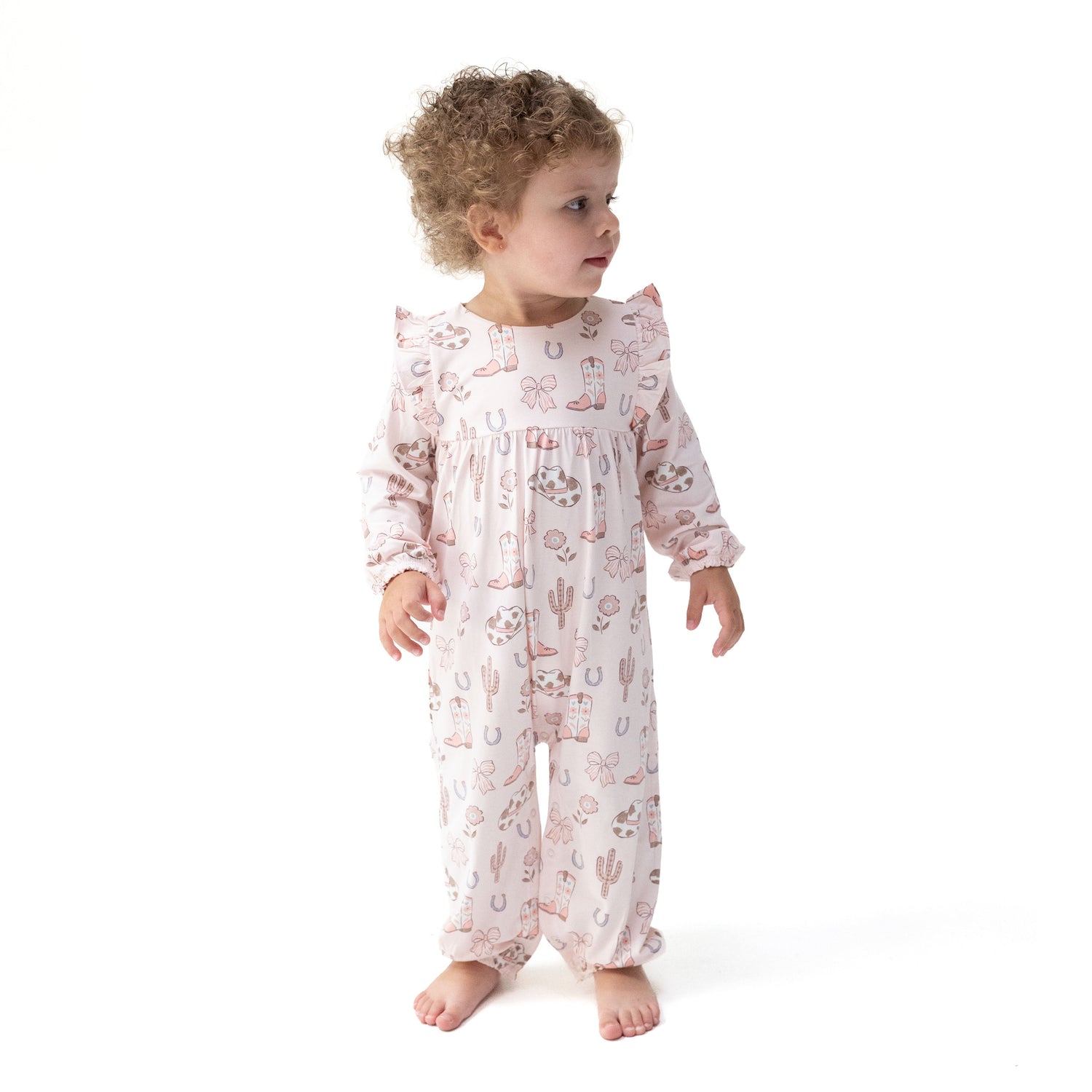 Viscose bamboo ruffle snap romper with a cowgirl boots and bows print