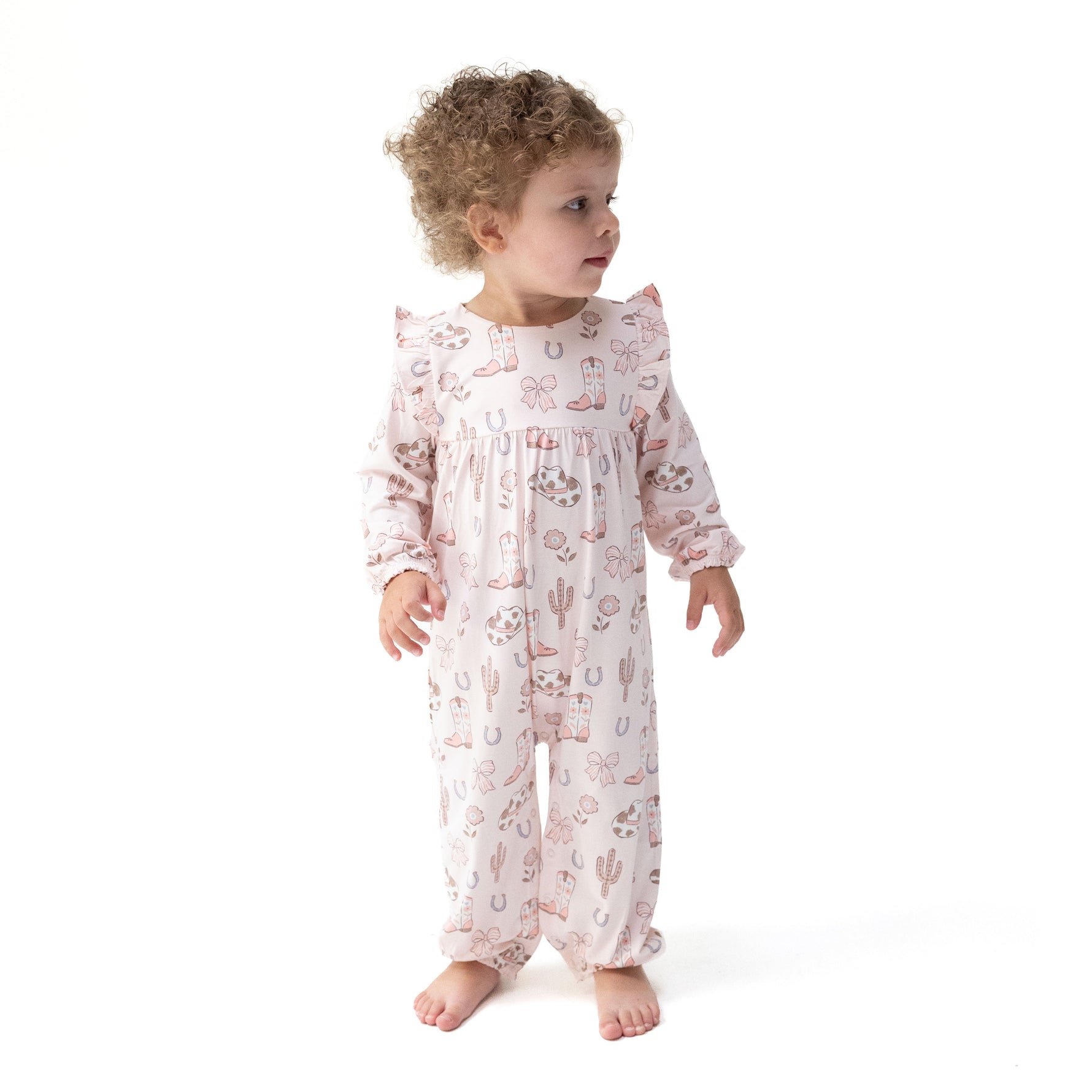 Viscose bamboo ruffle snap romper with a cowgirl boots and bows print