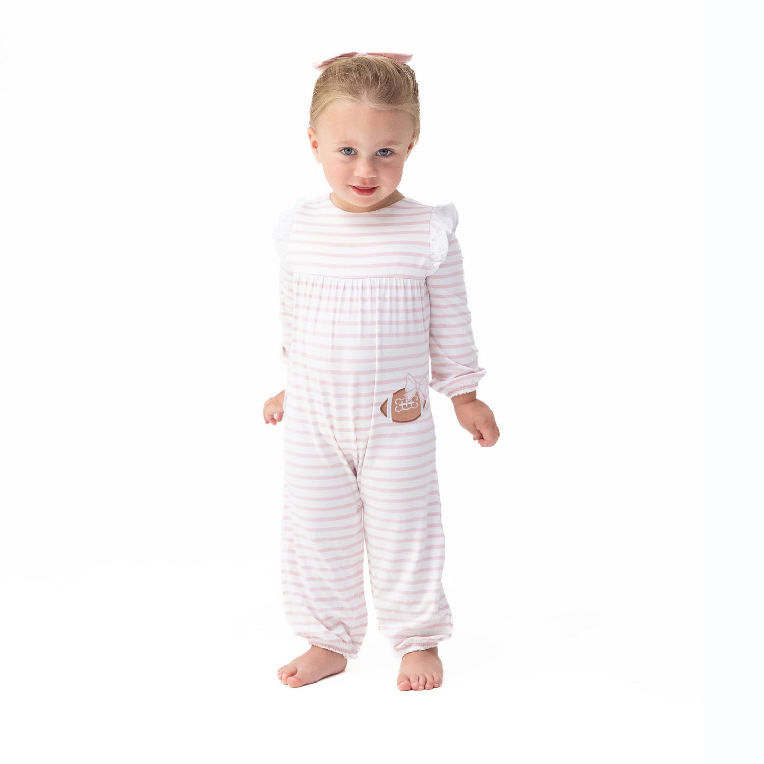 Baby romper with ruffle sleeves in a football dot and stripe print with snap closures