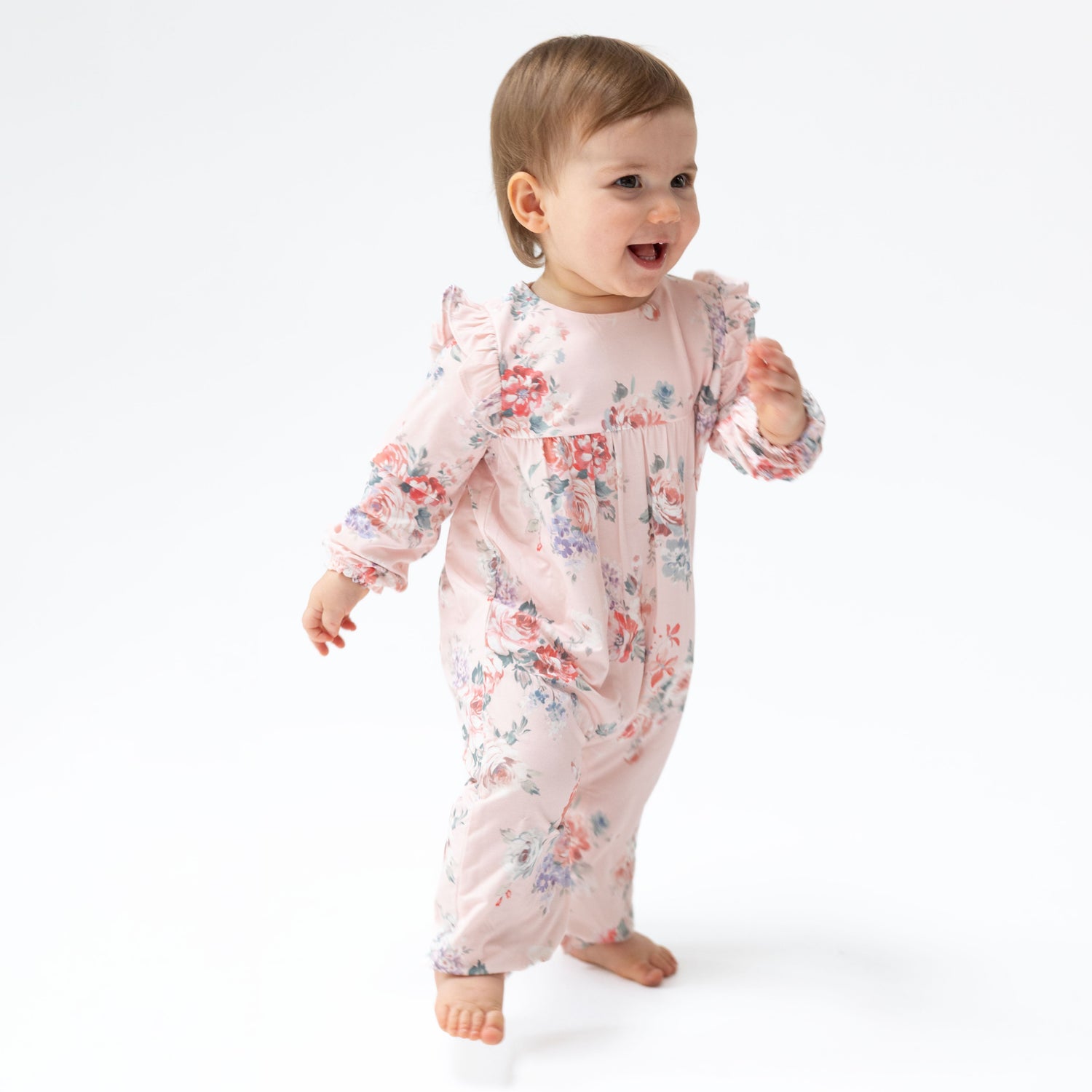 Ruffle sleeve snap romper in a painterly rose bouquet print with short ruffled sleeves