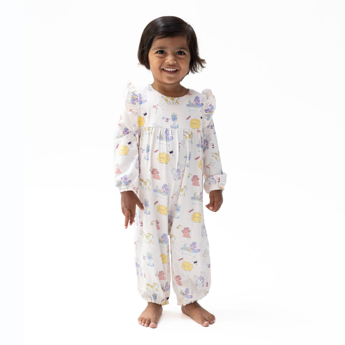 Baby romper with Spa Dogs print of pampered pups, ruffle sleeves, and snap closures along the bottom