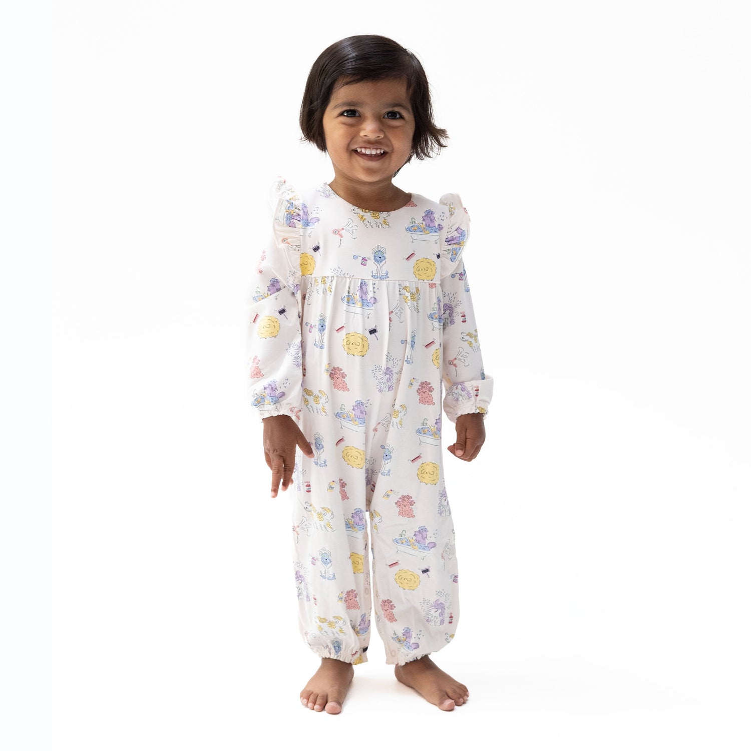 Baby romper with Spa Dogs print of pampered pups, ruffle sleeves, and snap closures along the bottom