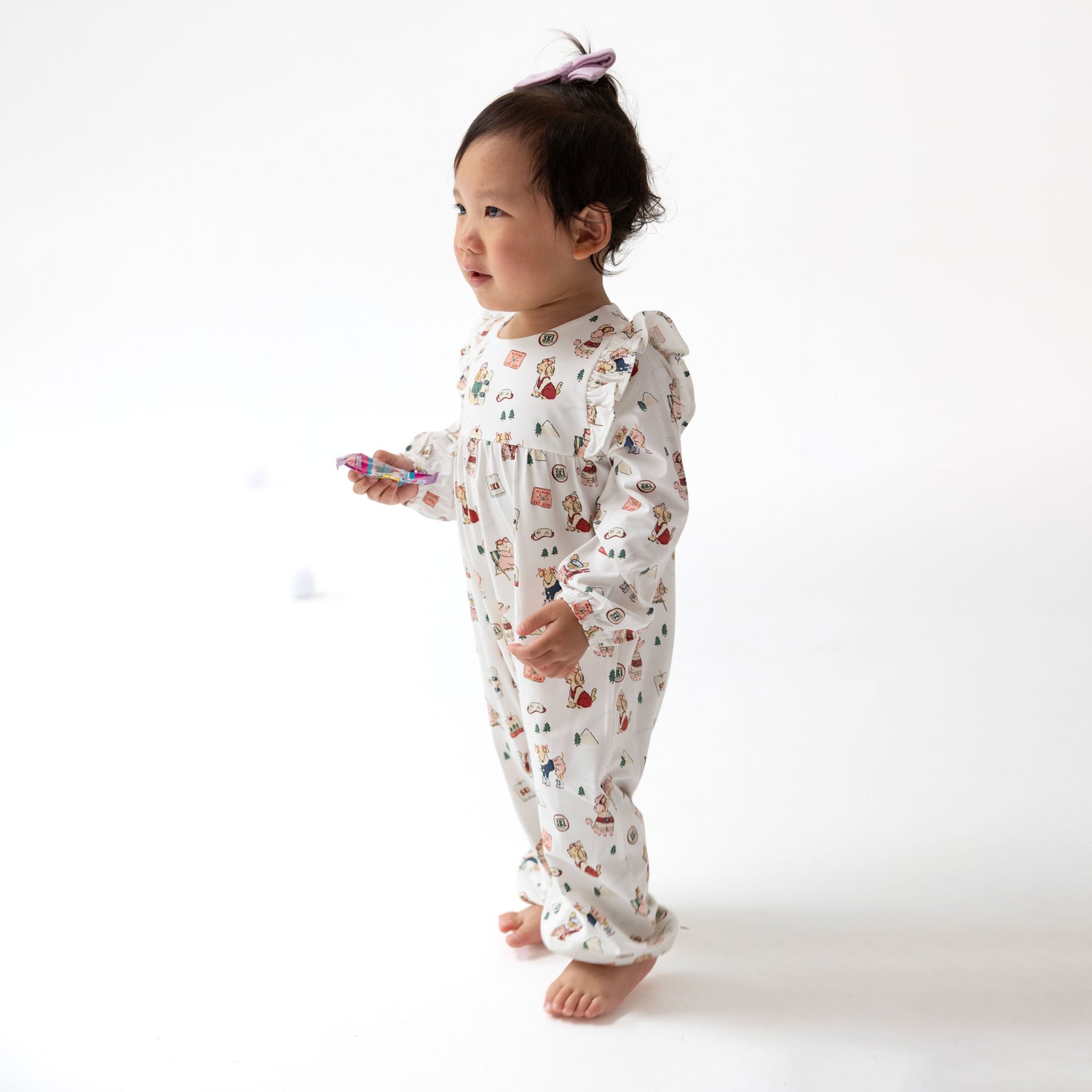 Ruffle sleeve snap romper in pink with a winter sports dog print