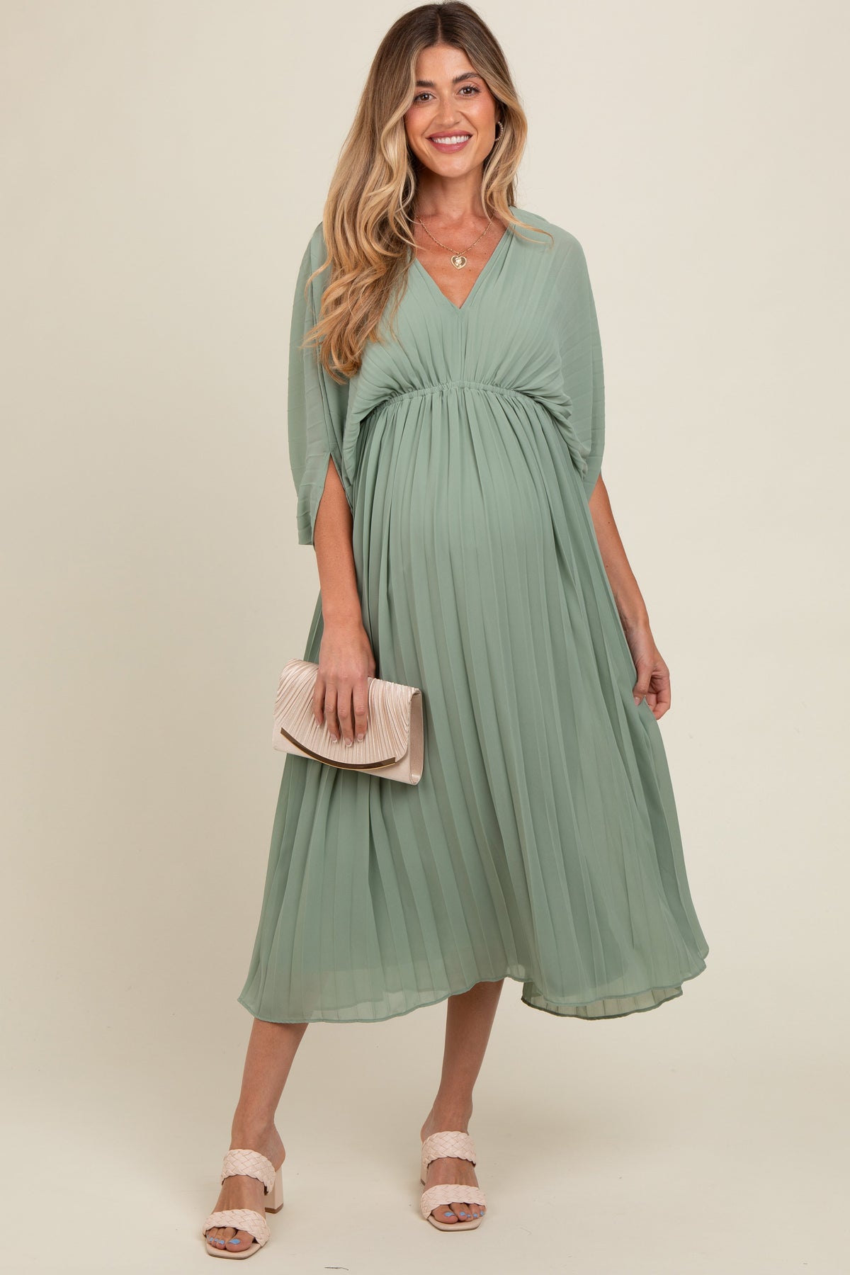 Light olive pleated maternity maxi dress with a V neckline and long flowing skirt
