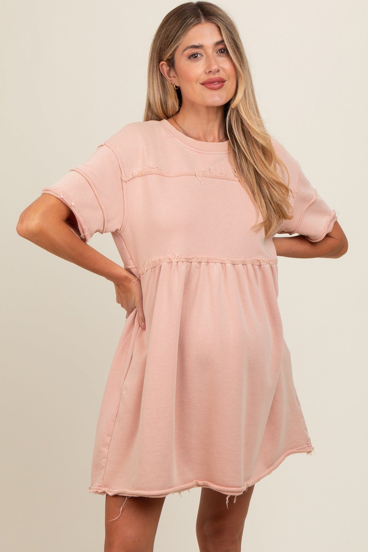 Mauve short sleeve maternity dress with raw hem edges and a relaxed fit over the bump.