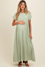 Light olive maternity maxi dress with ruffle trim at the empire waist and short flutter sleeves