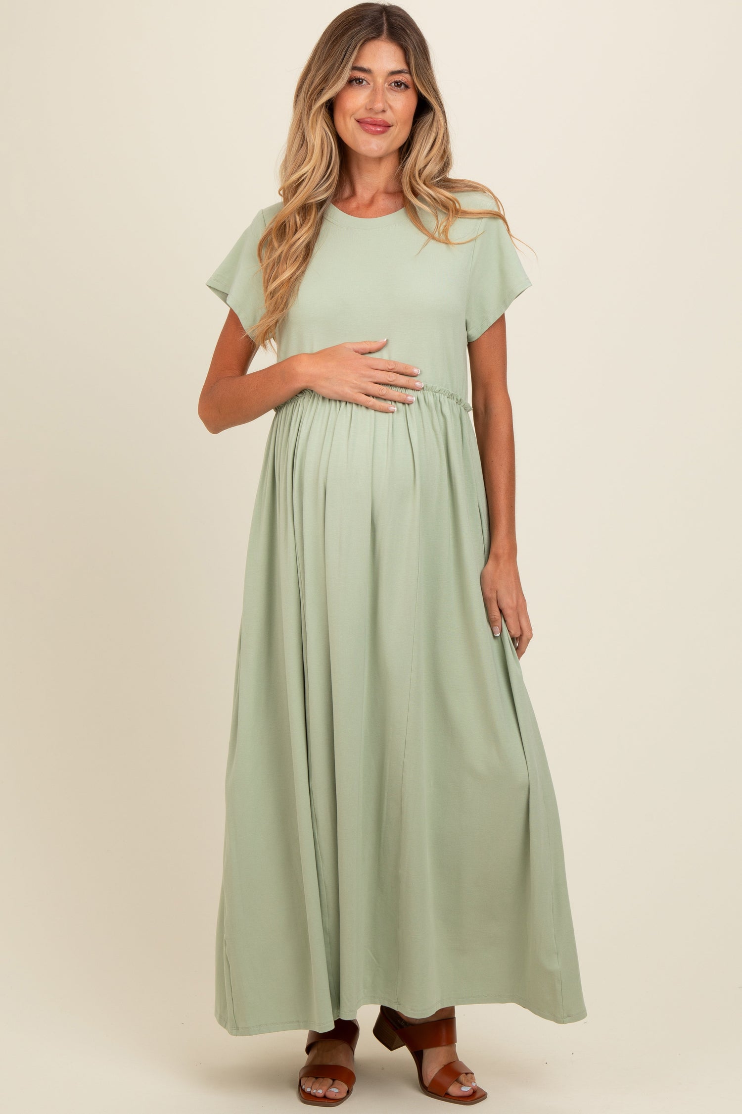 Light olive maternity maxi dress with ruffle trim at the empire waist and short flutter sleeves