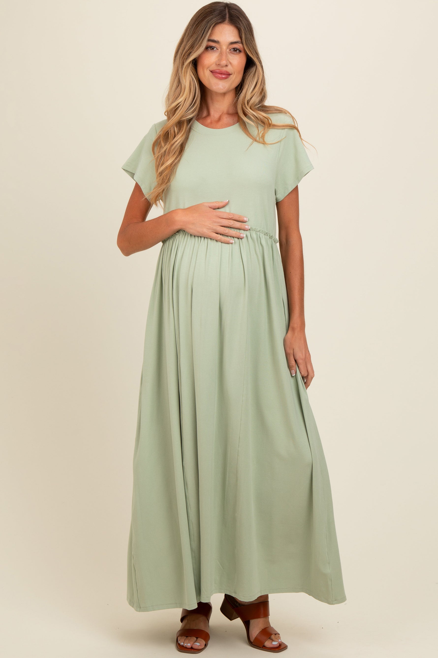 Light olive maternity maxi dress with ruffle trim at the empire waist and short flutter sleeves