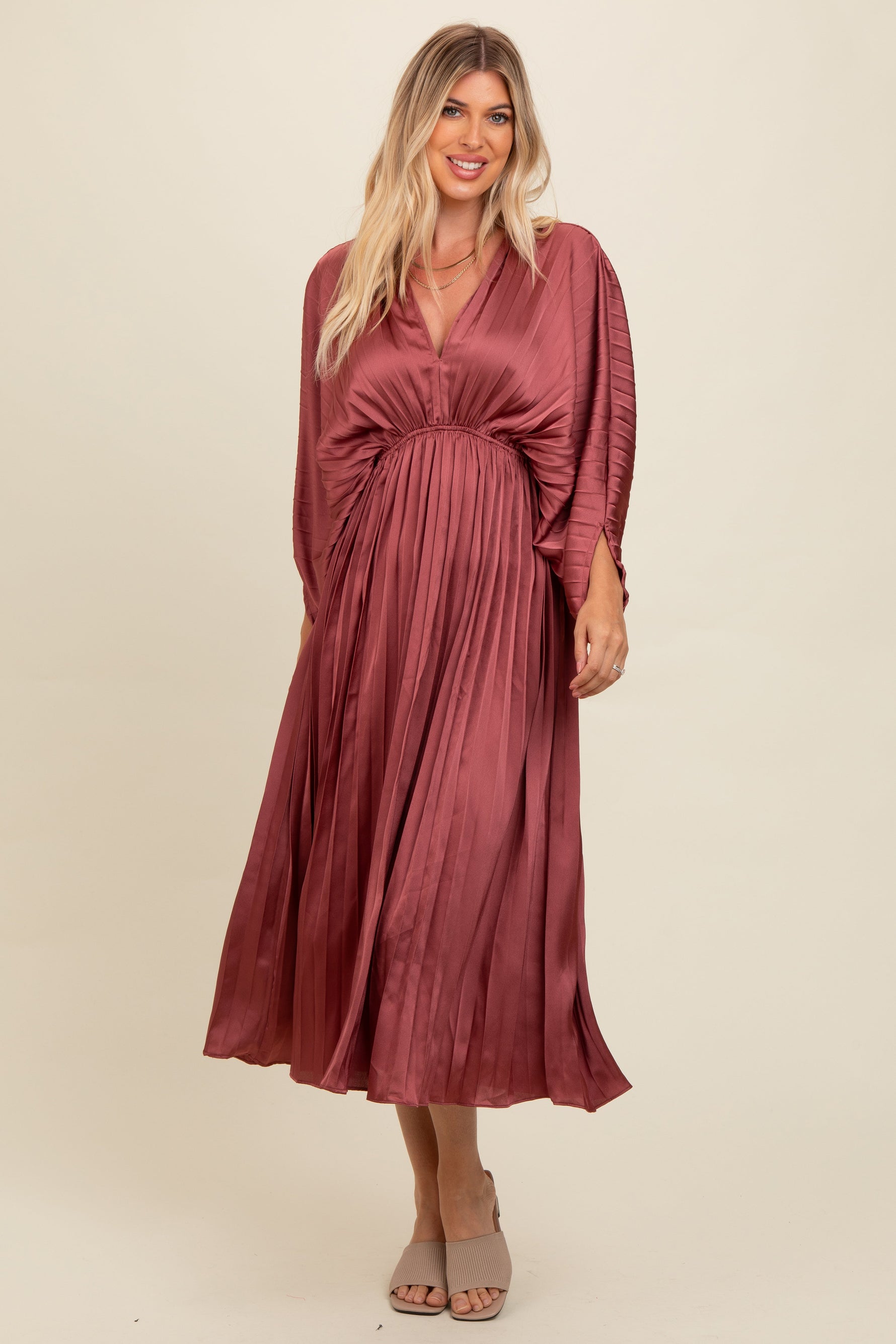 Mauve satin pleated maxi dress with a deep V-neckline, cinched waist, and relaxed batwing sleeves.