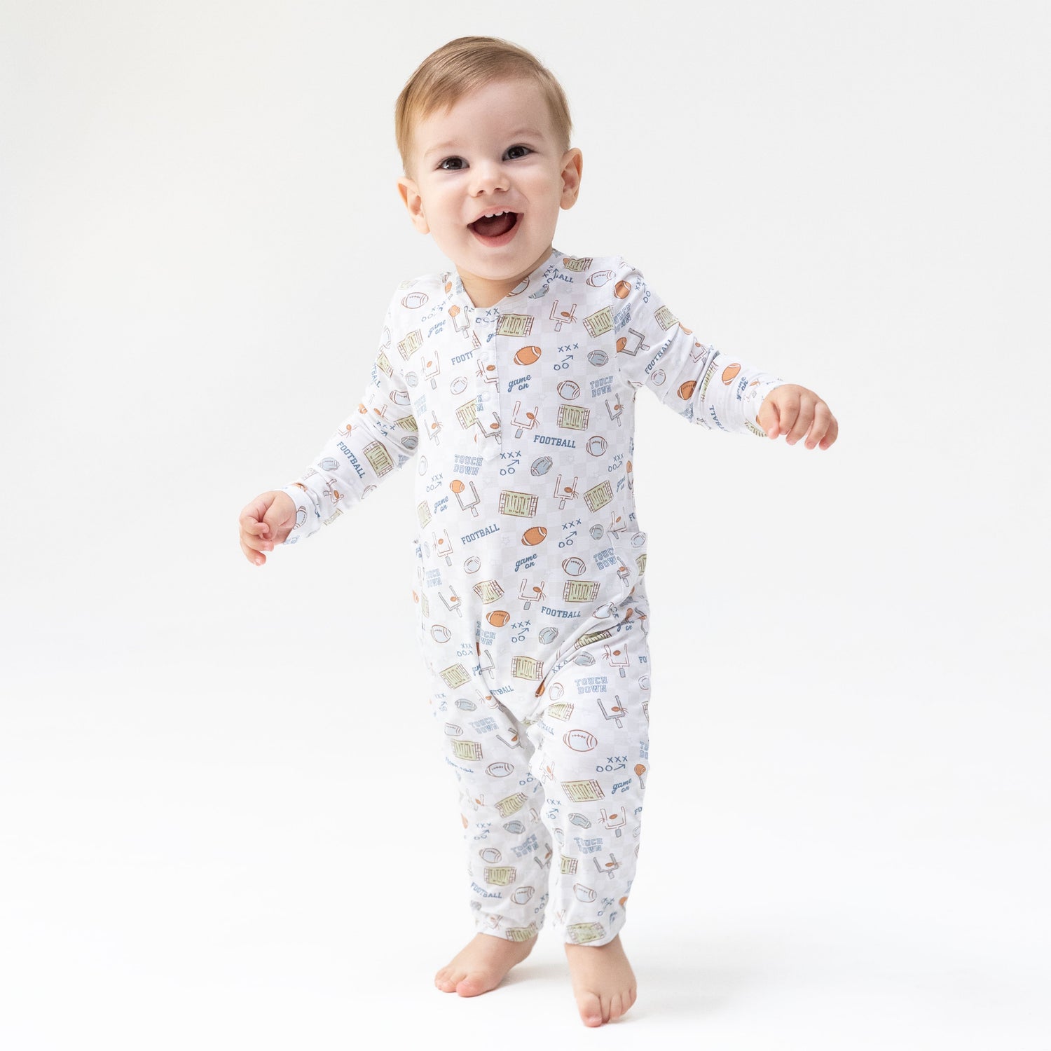 Baby romper in a football check pattern with a Henley neckline and snap closures