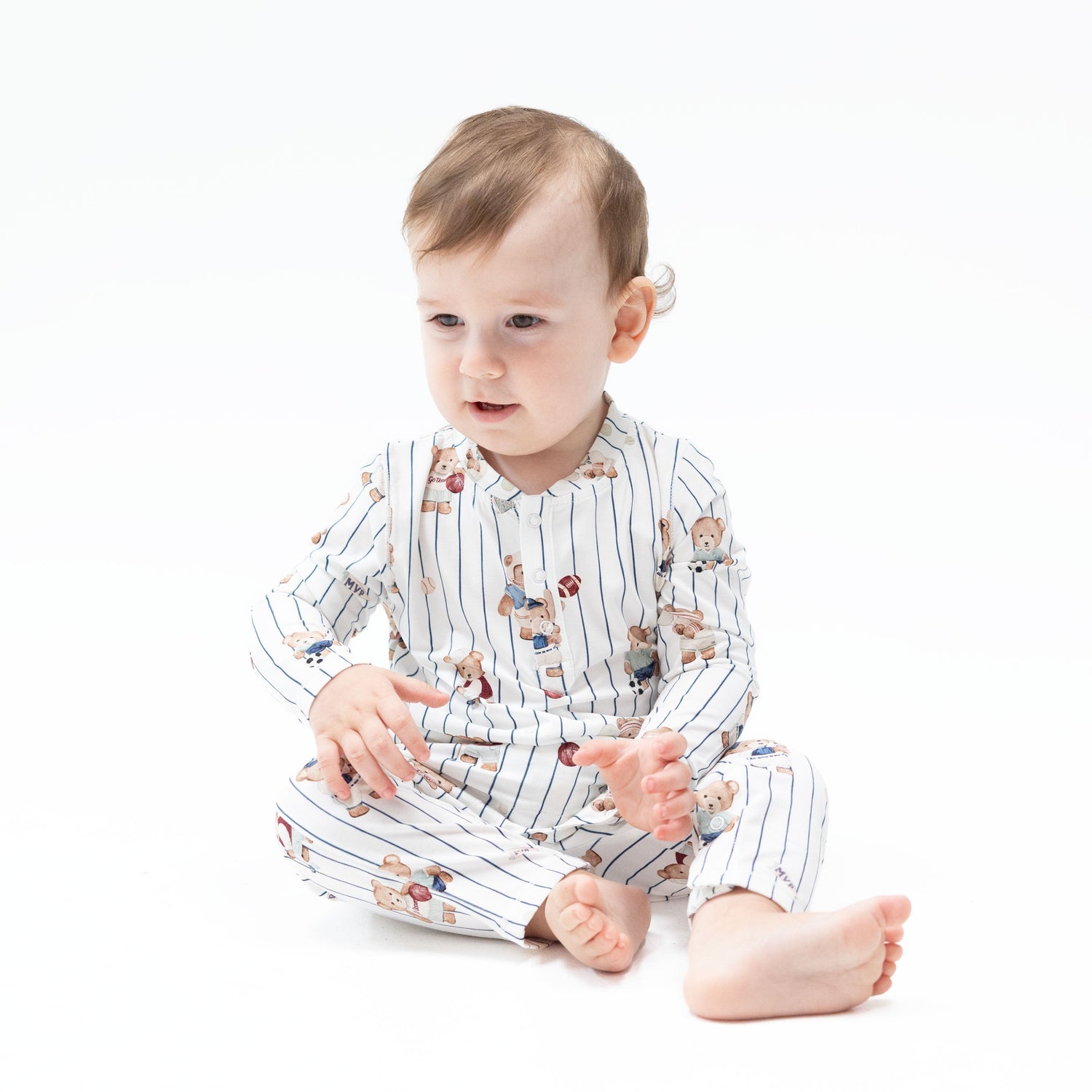 Baby romper in a mixed sports bears print with a Henley neckline and snap closures down the front and legs