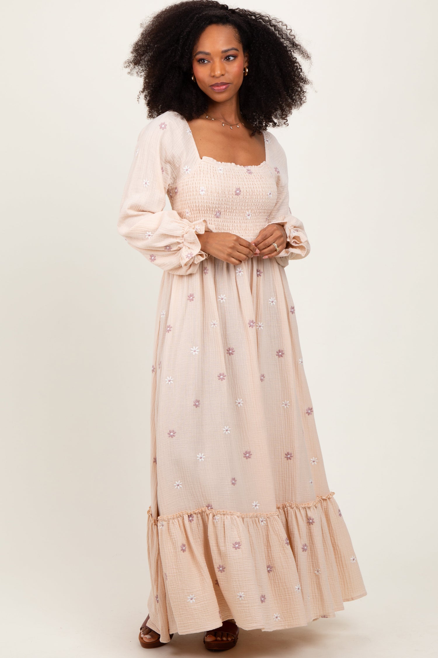 Cream long sleeve maxi dress with pastel floral embroidery, square neckline, puff sleeves, and tiered ruffle hem.