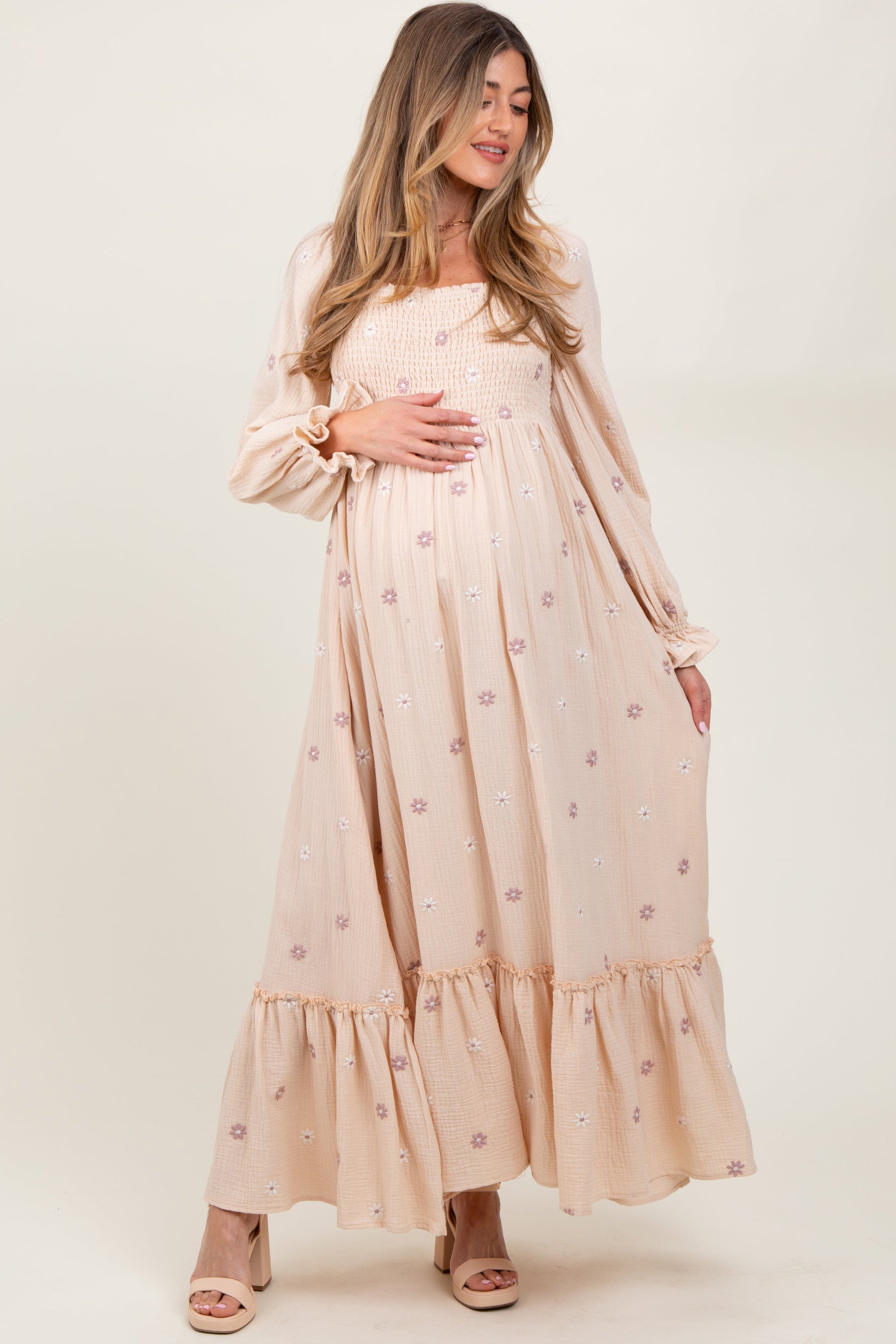 Cream long sleeve maternity dress with delicate floral accents and a flattering silhouette