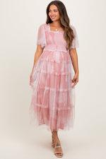 Pink smocked maternity midi dress with mesh ruffles, square neckline, short puff sleeves, and a tiered flowing skirt.
