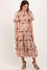 Peach and gray floral mesh midi dress with smocked bodice, flutter sleeves, crew neckline, and a tiered skirt.