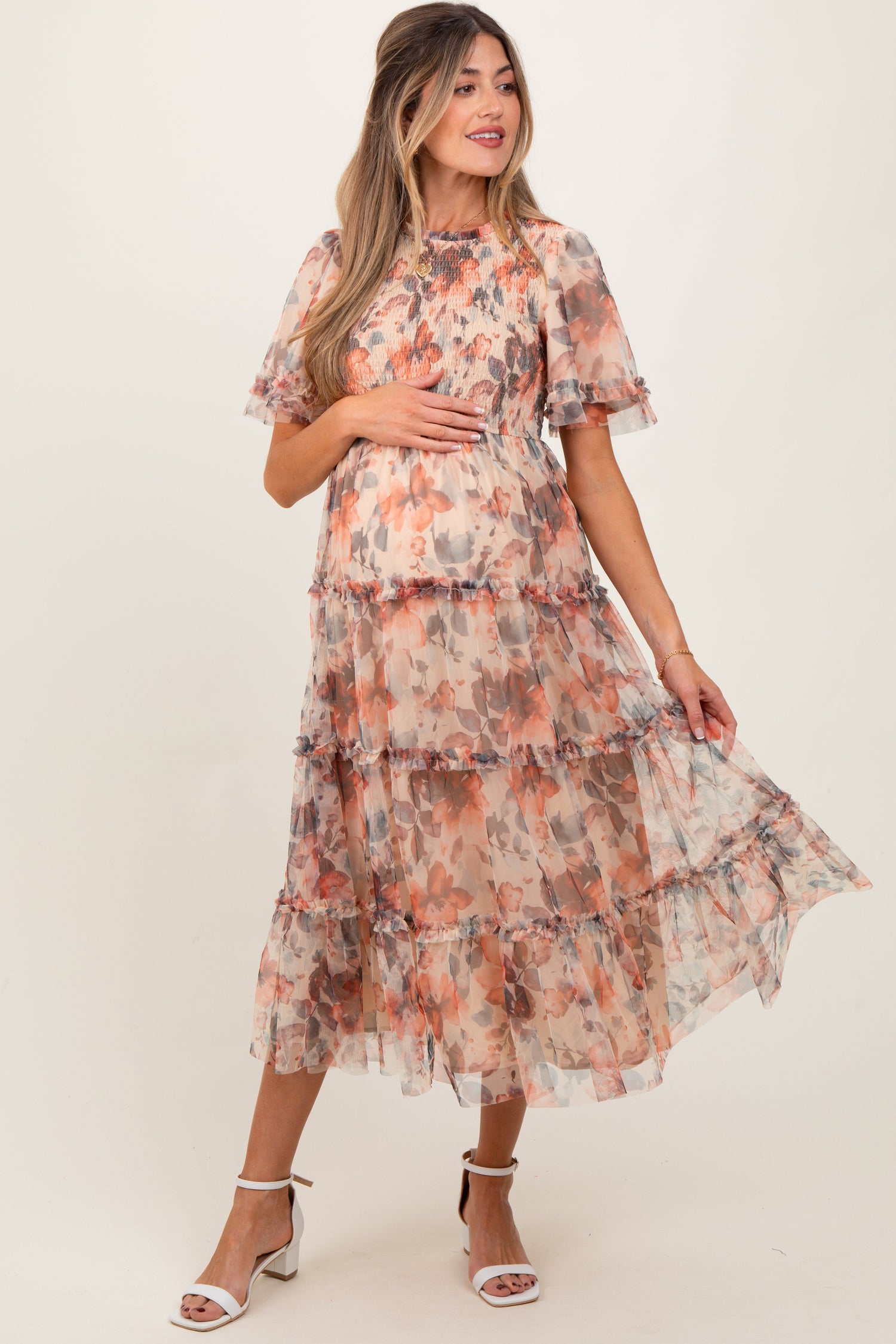 Peach floral mesh maternity midi dress with smocked bodice, flutter sleeves, and a flowy midi skirt.