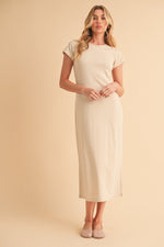 Cream crewneck short-sleeve midi dress worn with sandals by a standing model.