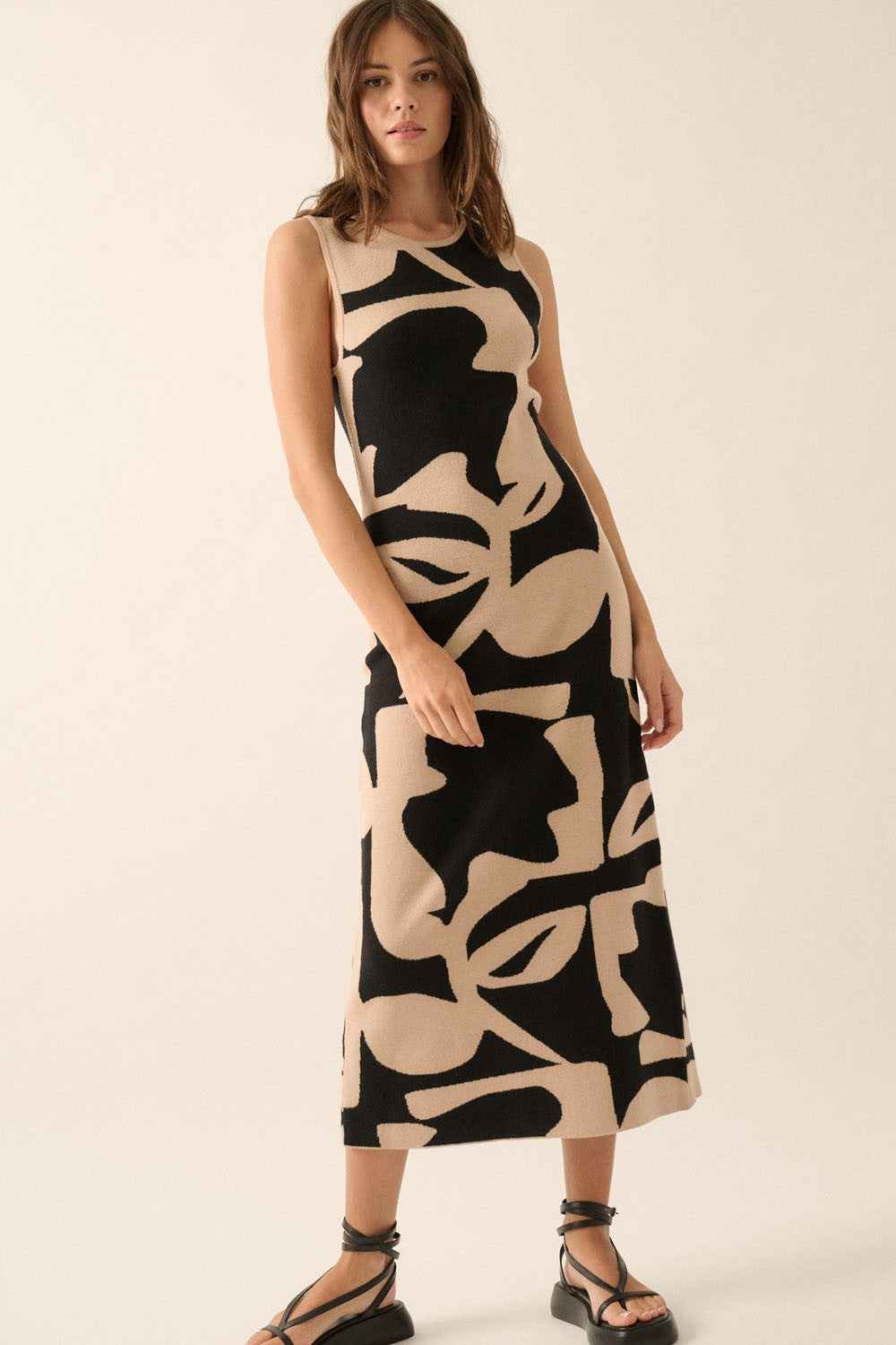 Sleeveless midi dress in black with a bold abstract print, soft knit fabric and a figure-skimming fit.