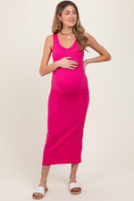 Model wearing a flowing fuchsia V-neck tank maternity maxi dress by PinkBlush, standing elegantly.
