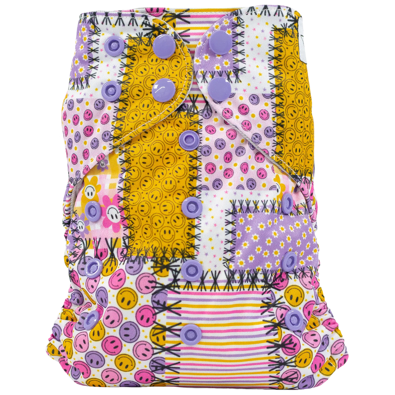 Slim Fit AIO Cloth Diaper with colorful patchwork design and purple snaps.
