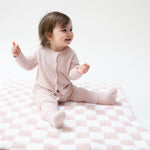 Chenille baby stroller blanket in a blush pink and white checkerboard pattern.