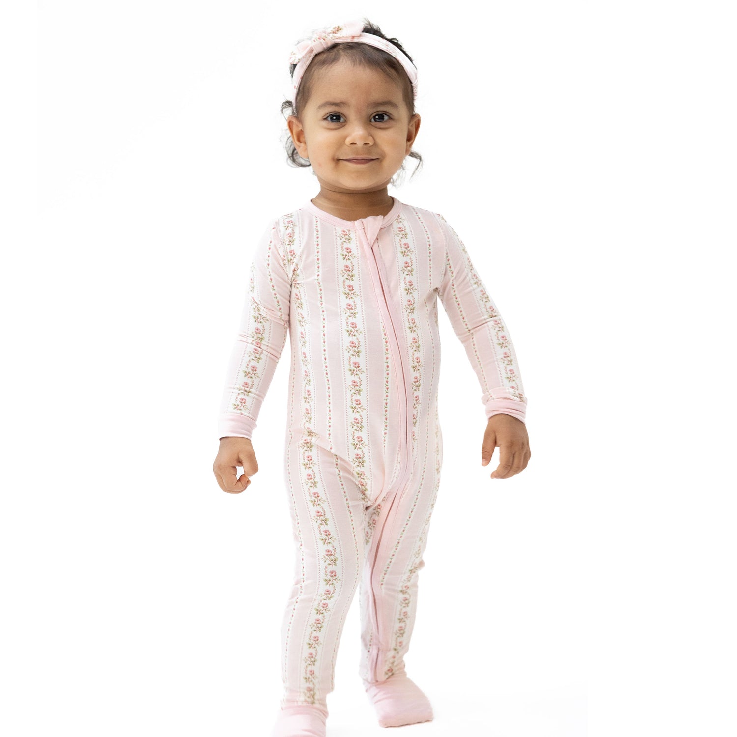 Convertible romper in a soft striped Antoinette print with a two-way zipper and covered footies.