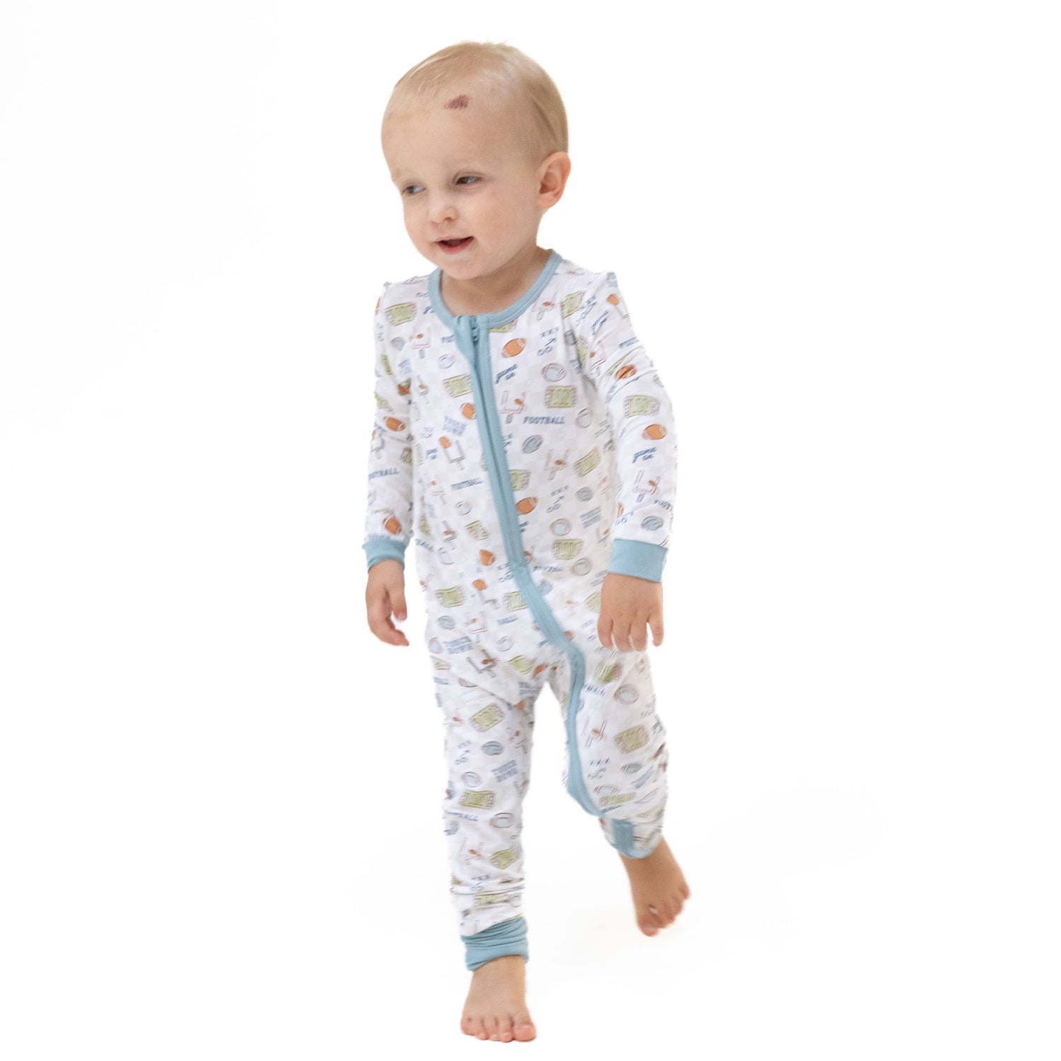 Convertible romper with a football check print, zipper closure, chin guard, and foot grippers