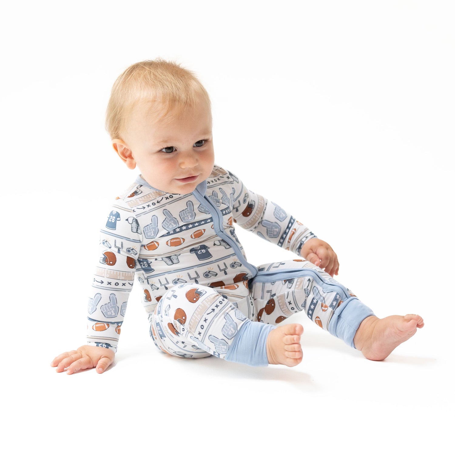 Convertible baby romper in a football stripe print with two-way zipper and footed legs